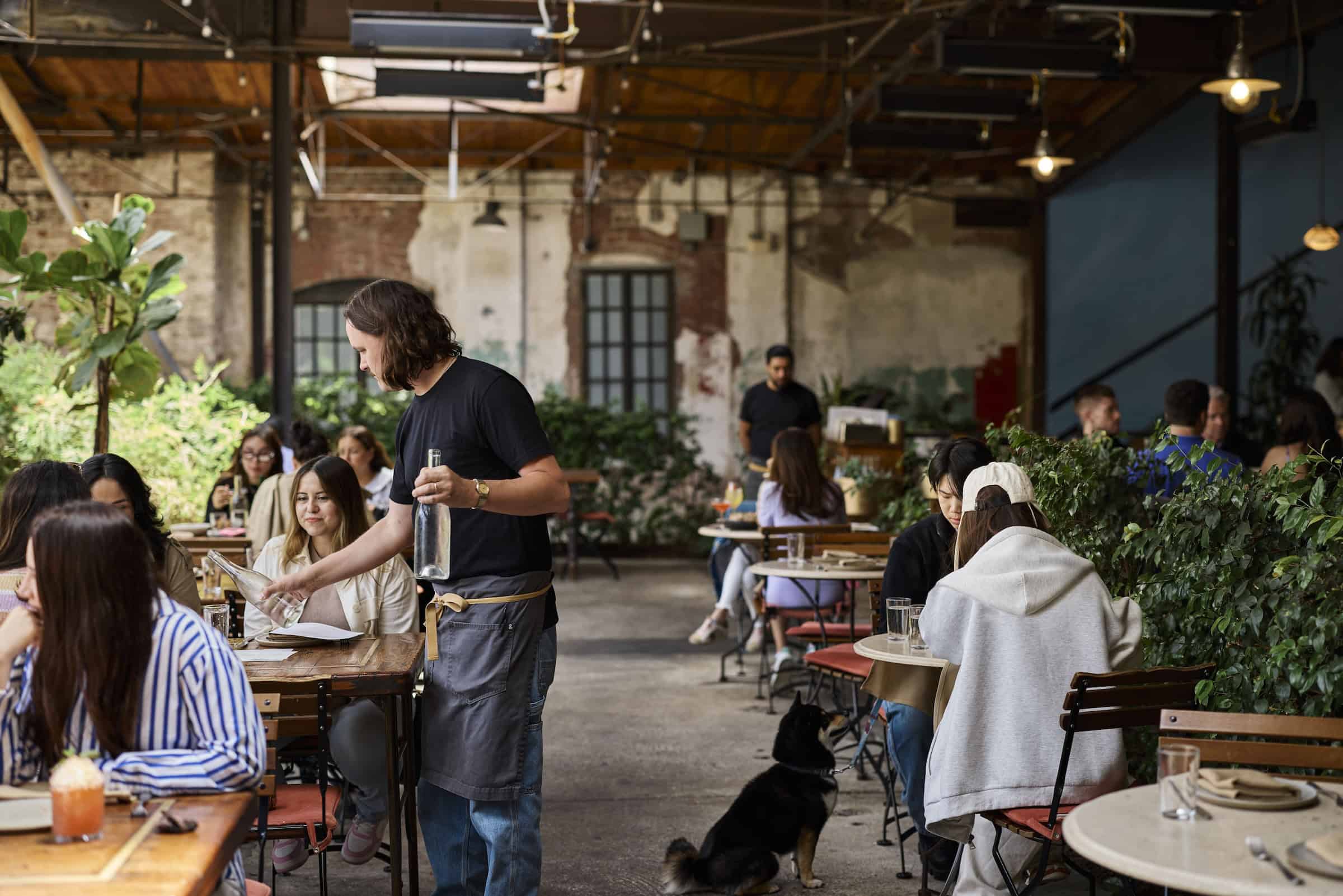 a group of people sitting at tables in the courtyard