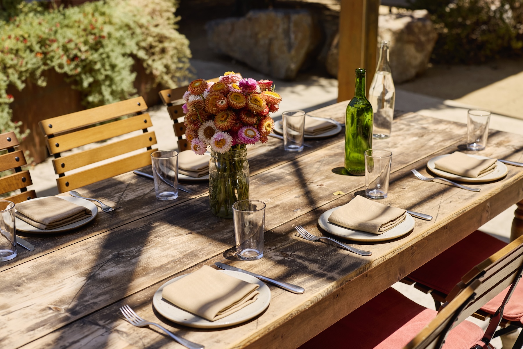 Outdoor table set up with flowers on the table