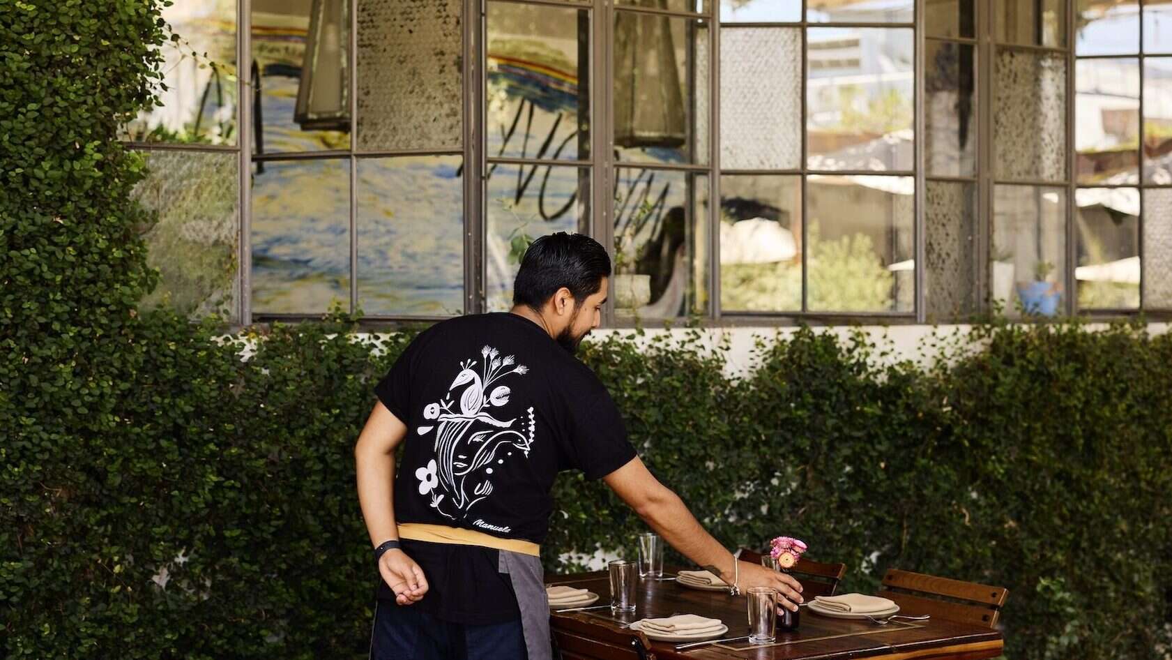 Manuela LA Staff member setting a table