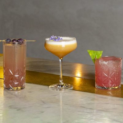 three cocktails on a bar