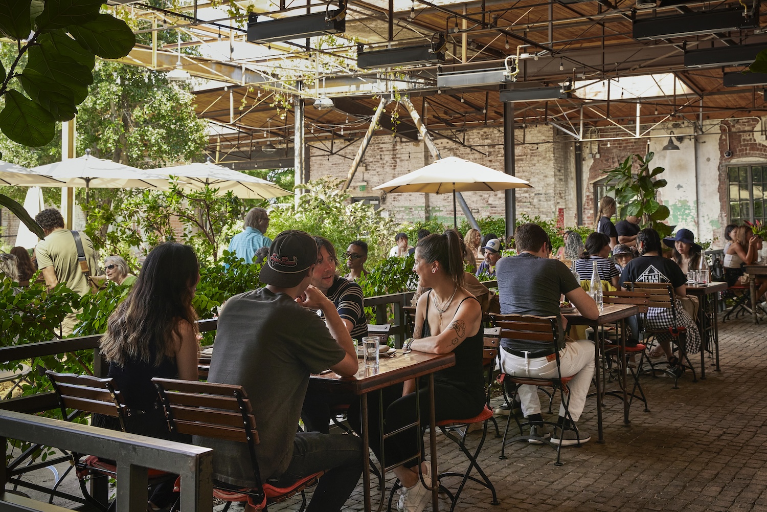 Several different plates of food on a table, each with a colorful arraignment of ingredients.