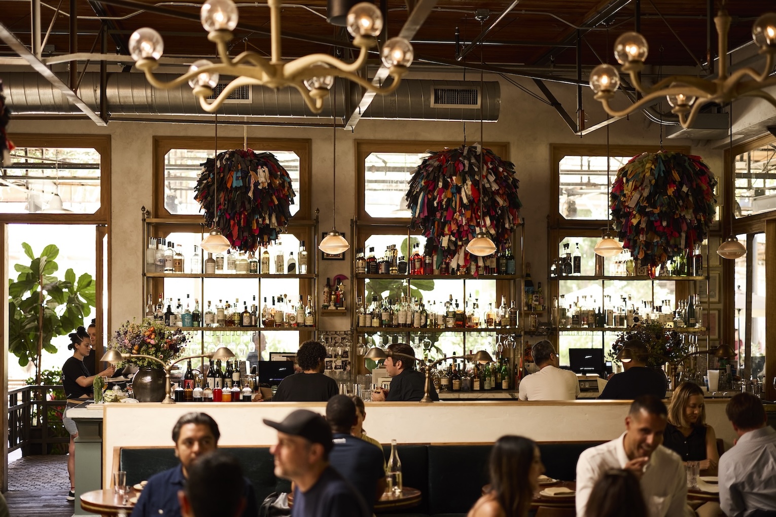 The bar full of people with Phyllida Barlow pompoms hanging from the ceiling